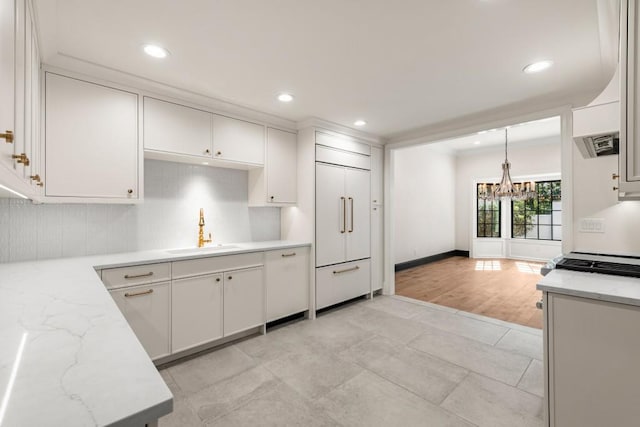 650 Moores Mill Rd NW Unit 1, Atlanta, GA 30327 - kitchen featuring paneled refrigerator, a chandelier, tasteful backsplash, white cabinets, and recessed lighting