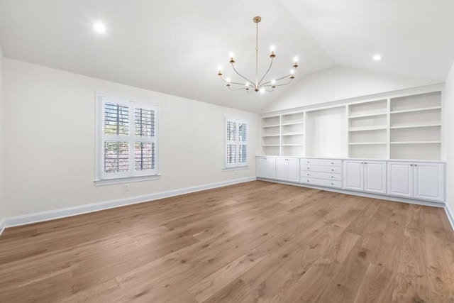 650 Moores Mill Rd NW Unit 1, Atlanta, GA 30327 - unfurnished dining area with vaulted ceiling, a chandelier, built in features, and light wood-style floors