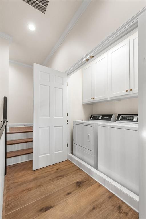 650 Moores Mill Rd NW Unit 1, Atlanta, GA 30327 - laundry room with cabinet space, washer and dryer, ornamental molding, light wood finished floors, and recessed lighting
