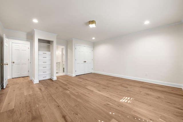 650 Moores Mill Rd NW Unit 1, Atlanta, GA 30327 - unfurnished bedroom with crown molding, two closets, recessed lighting, light wood-style floors, and connected bathroom