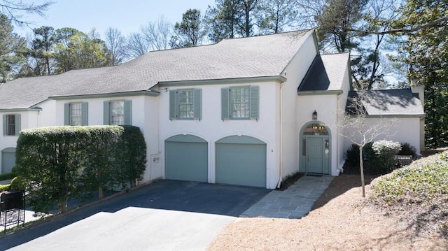 650 Moores Mill Rd NW Unit 1, Atlanta, GA 30327 - view of front facade with asphalt driveway, a shingled roof, a garage, and stucco siding
