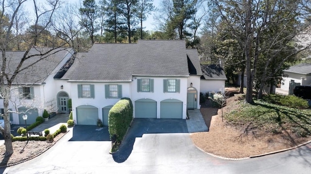650 Moores Mill Rd NW Unit 1, Atlanta, GA 30327 - view of front of property featuring stucco siding, asphalt driveway, roof with shingles, and an attached garage