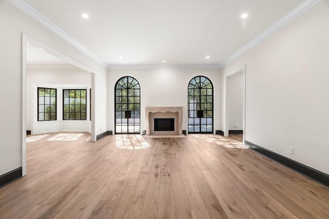 650 Moores Mill Rd NW Unit 1, Atlanta, GA 30327 - unfurnished living room featuring light wood-type flooring, a fireplace with flush hearth, recessed lighting, and ornamental molding