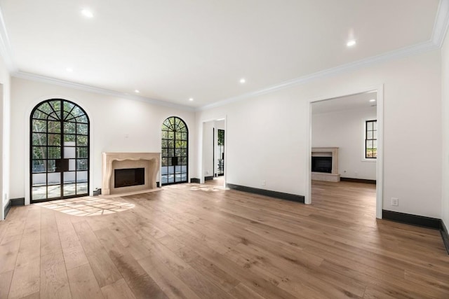 650 Moores Mill Rd NW Unit 1, Atlanta, GA 30327 - unfurnished living room with a fireplace, light wood-type flooring, healthy amount of natural light, ornamental molding, and recessed lighting