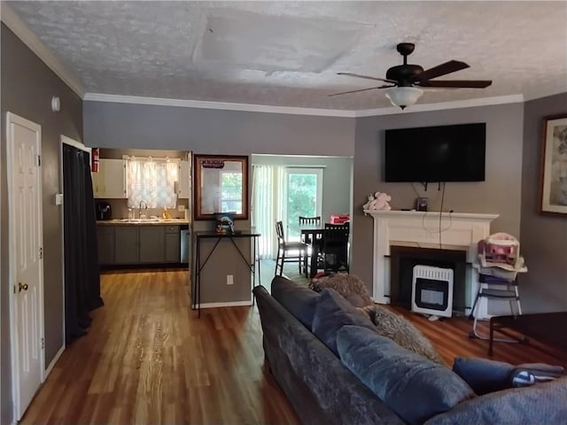 living room featuring ornamental molding, ceiling fan, sink, and hardwood / wood-style flooring