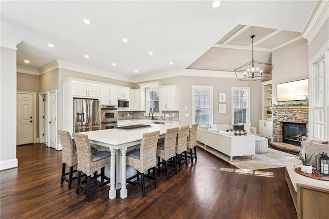 dining area featuring a chandelier, dark wood finished floors, crown molding, and baseboards