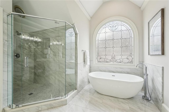 bathroom featuring a stall shower, lofted ceiling, and a freestanding tub