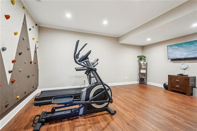 exercise area with recessed lighting, baseboards, wood finished floors, and ornamental molding