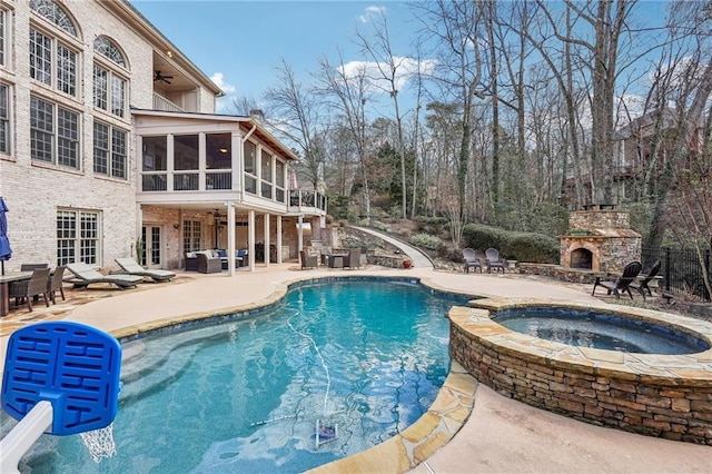 view of pool featuring a ceiling fan, an outdoor living space with a fireplace, a sunroom, french doors, and a patio area