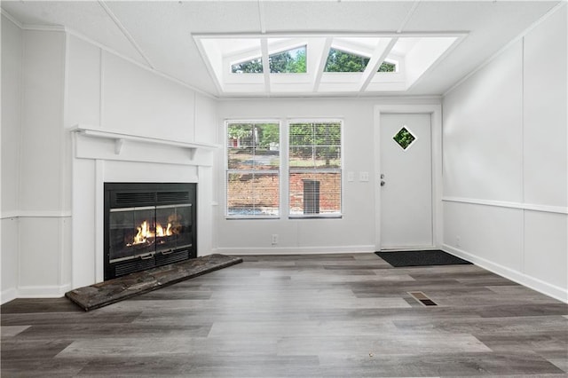 unfurnished living room with ornamental molding, hardwood / wood-style floors, and vaulted ceiling