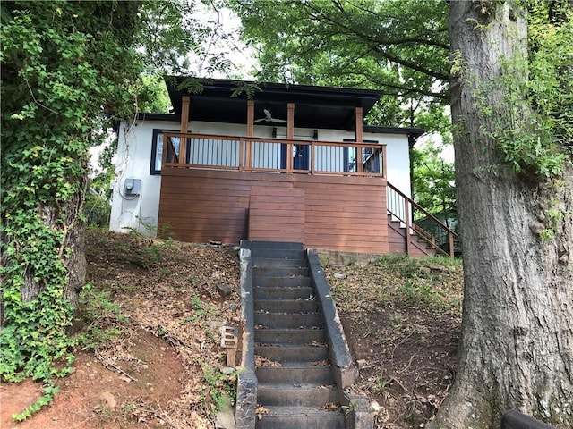 view of front of home with stairway and stucco siding