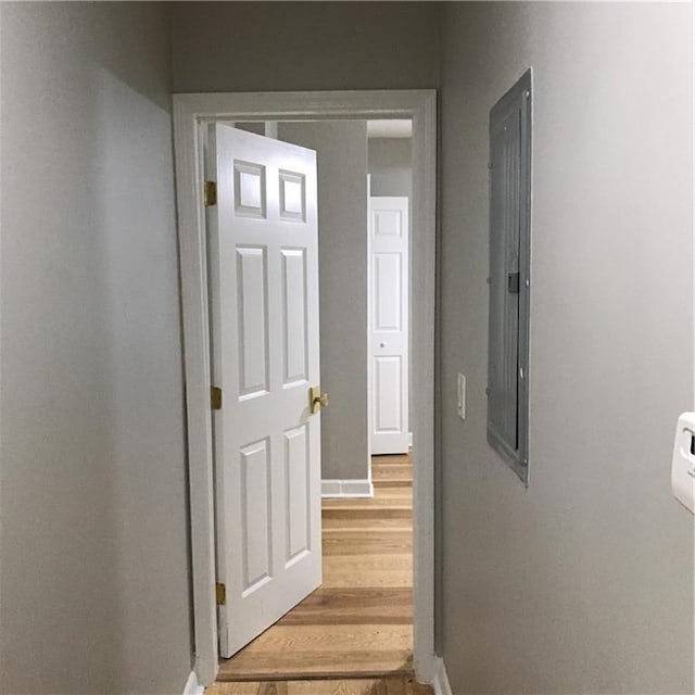 hallway featuring light wood-style floors and baseboards