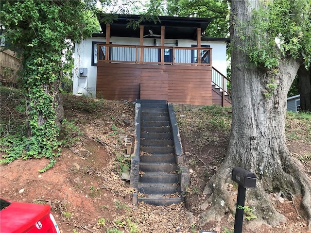 exterior space featuring stairs and stucco siding