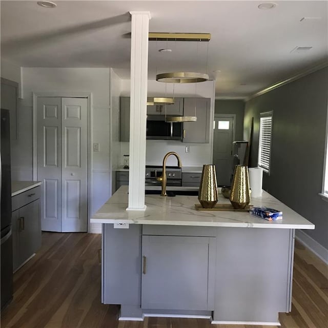 kitchen with freestanding refrigerator, dark wood finished floors, gray cabinetry, and light stone countertops