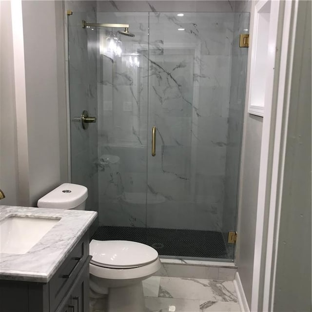 bathroom with toilet, marble finish floor, a marble finish shower, and vanity