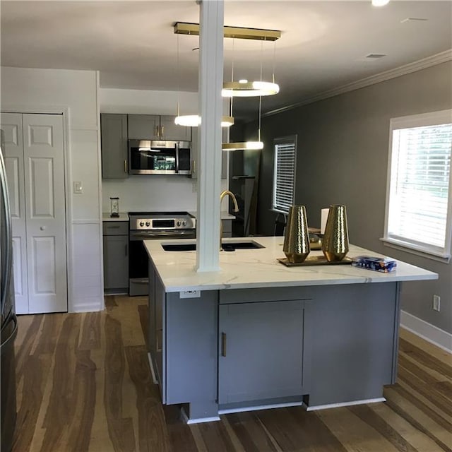 kitchen with gray cabinets, ornamental molding, stainless steel appliances, and dark wood-type flooring