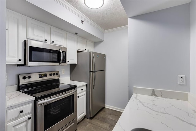 795 Hammond Dr Unit 503, Sandy Springs, GA 30328 - kitchen with appliances with stainless steel finishes, a textured ceiling, white cabinetry, dark wood-style flooring, and light stone counters