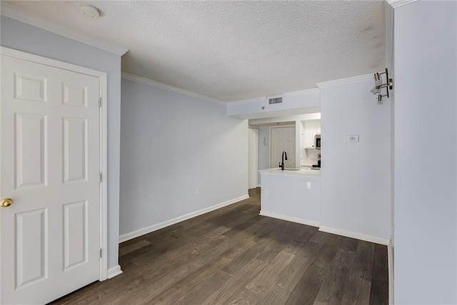795 Hammond Dr Unit 503, Sandy Springs, GA 30328 - unfurnished living room featuring dark wood-type flooring, a textured ceiling, and crown molding