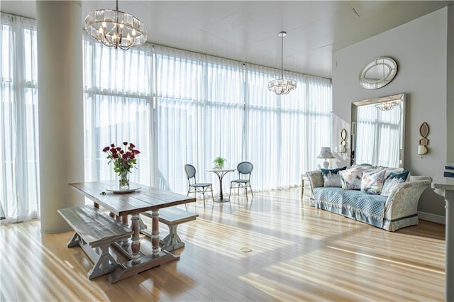 dining room featuring light hardwood / wood-style flooring and an inviting chandelier