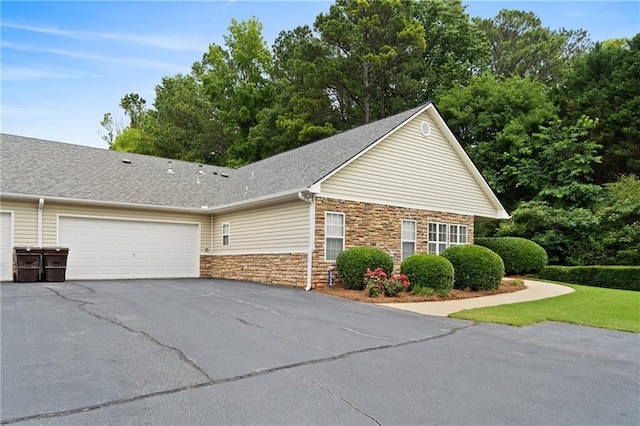 3734 Villa Springs Cir, Powder Springs, GA 30127 - view of front of house featuring stone siding, an attached garage, asphalt driveway, and roof with shingles