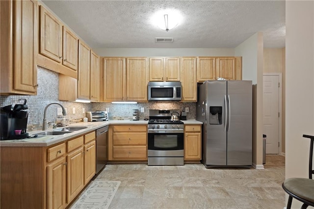 3734 Villa Springs Cir, Powder Springs, GA 30127 - kitchen featuring appliances with stainless steel finishes, a sink, light brown cabinets, and a textured ceiling