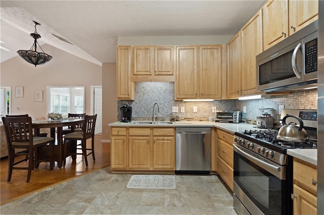 3734 Villa Springs Cir, Powder Springs, GA 30127 - kitchen with appliances with stainless steel finishes, light brown cabinets, vaulted ceiling, and backsplash