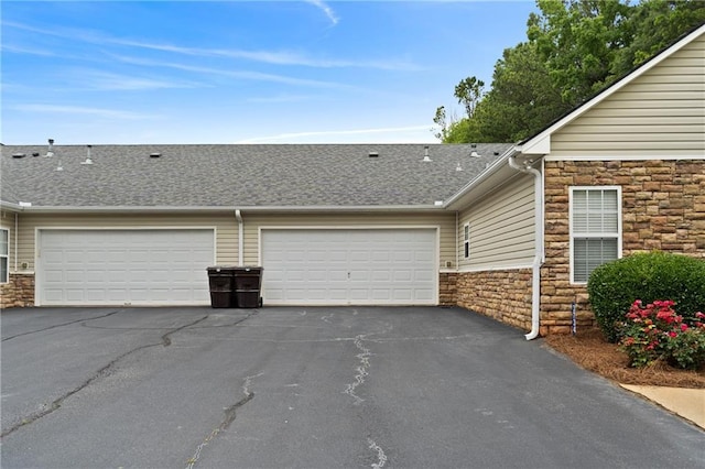 3734 Villa Springs Cir, Powder Springs, GA 30127 - view of front of home featuring stone siding, asphalt driveway, a garage, and a shingled roof