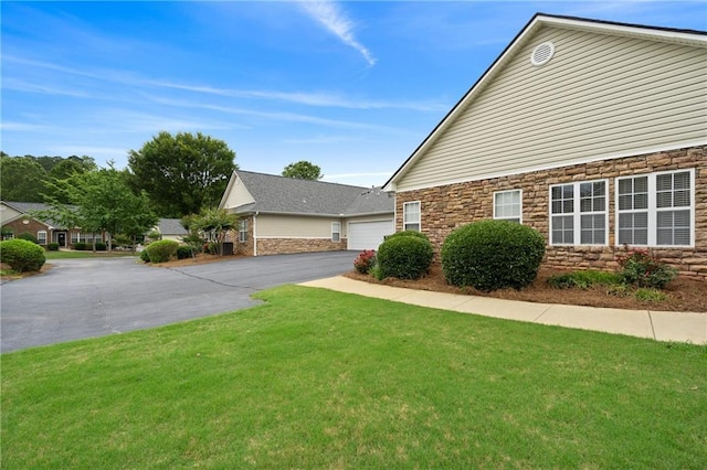 3734 Villa Springs Cir, Powder Springs, GA 30127 - view of side of property with stone siding, a lawn, and driveway