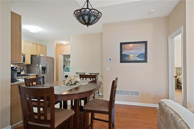 3734 Villa Springs Cir, Powder Springs, GA 30127 - dining room featuring wood finished floors, washer / clothes dryer, and baseboards