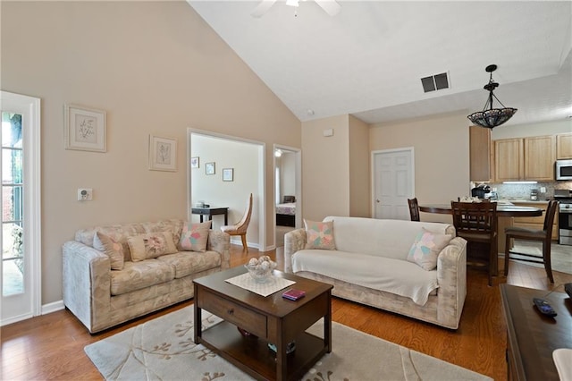 3734 Villa Springs Cir, Powder Springs, GA 30127 - living area with wood finished floors, high vaulted ceiling, ceiling fan, and baseboards