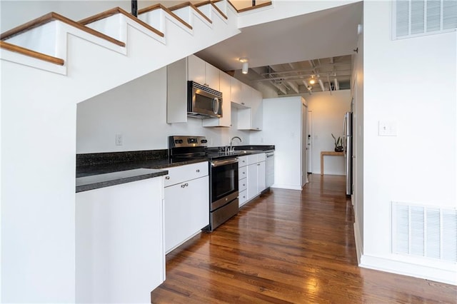1596 Cleveland Ave Unit 301, East Point, GA 30344 - kitchen with stainless steel appliances, dark wood-style floors, and dark countertops