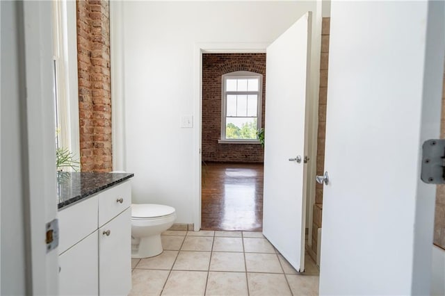 1596 Cleveland Ave Unit 301, East Point, GA 30344 - bathroom featuring brick wall, vanity, and tile patterned floors