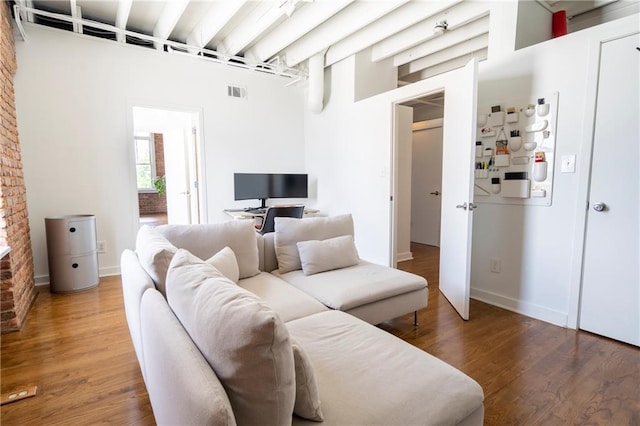 1596 Cleveland Ave Unit 301, East Point, GA 30344 - living room featuring a towering ceiling, wood finished floors, and beamed ceiling