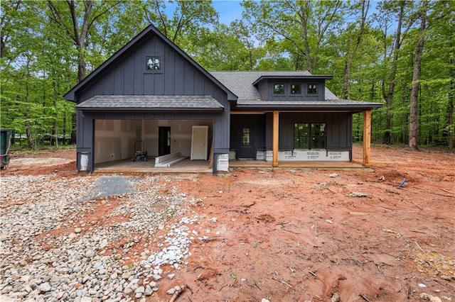 1687 Harmony Rd, Temple, GA 30179 - view of front of home with board and batten siding, roof with shingles, an attached garage, and covered porch