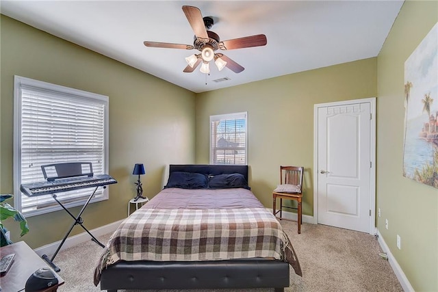 bedroom featuring baseboards, visible vents, ceiling fan, and carpet flooring