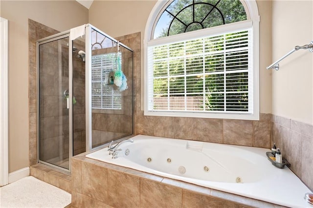 full bath featuring a shower stall and a tub with jets