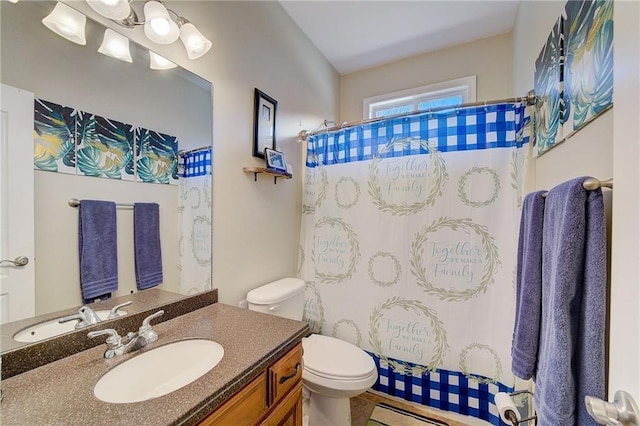 bathroom with a shower with shower curtain, vanity, and toilet