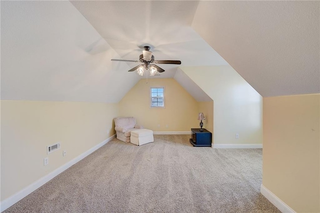 additional living space featuring lofted ceiling, carpet flooring, a ceiling fan, and baseboards