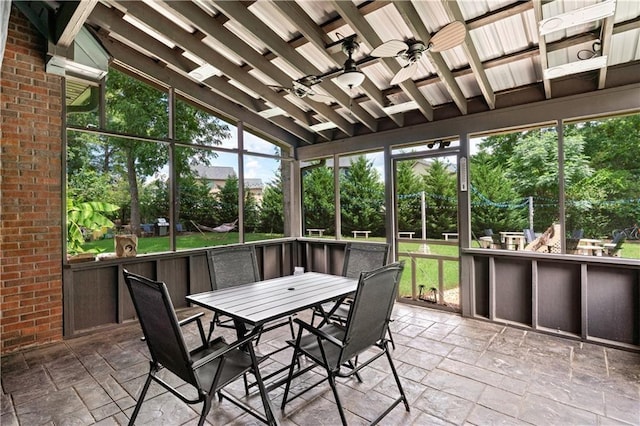 sunroom featuring vaulted ceiling and ceiling fan