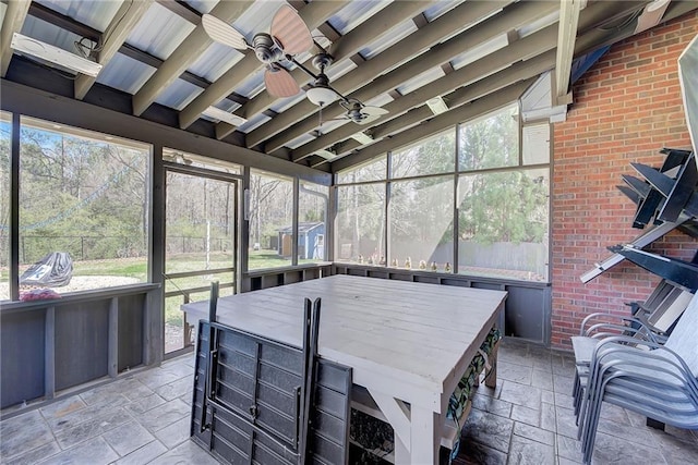 sunroom with ceiling fan and lofted ceiling