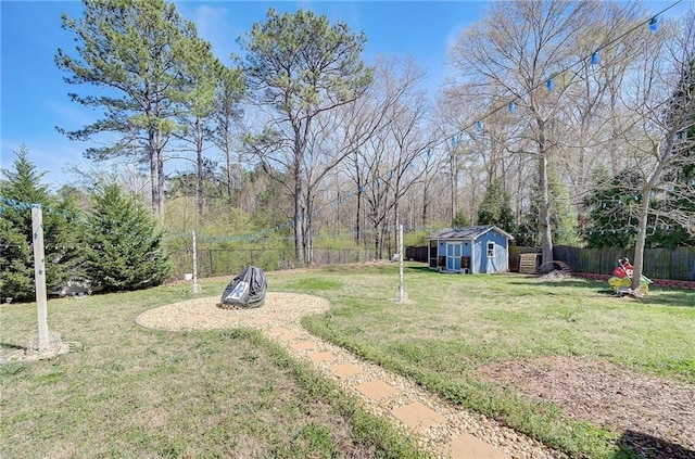 view of yard with a fenced backyard, an outdoor structure, and a storage shed