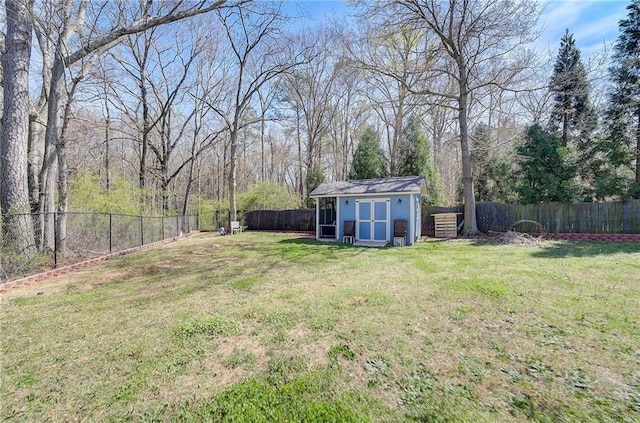 view of yard with a fenced backyard, an outdoor structure, and a storage unit