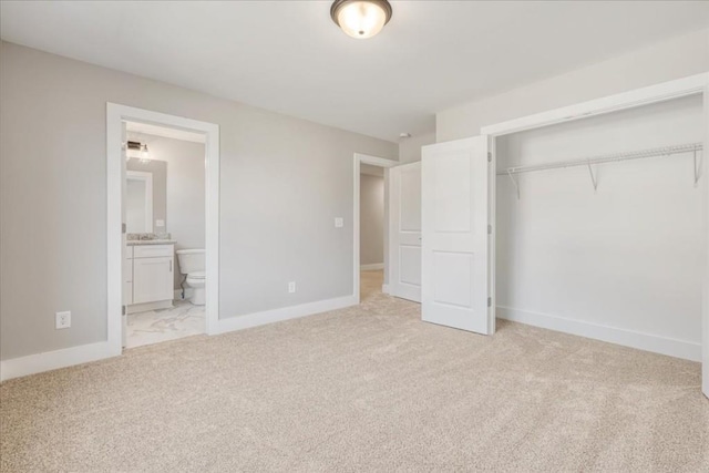 unfurnished bedroom with light carpet, a closet, and connected bathroom