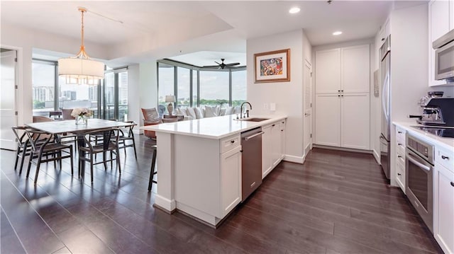 2795 Peachtree Rd NE Unit 1009, Atlanta, GA 30305 - kitchen with stainless steel appliances, a sink, a peninsula, recessed lighting, and dark wood-style flooring