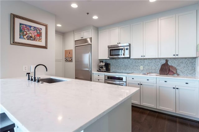 2795 Peachtree Rd NE Unit 1009, Atlanta, GA 30305 - kitchen featuring stainless steel appliances, a sink, decorative backsplash, dark wood-style flooring, and recessed lighting