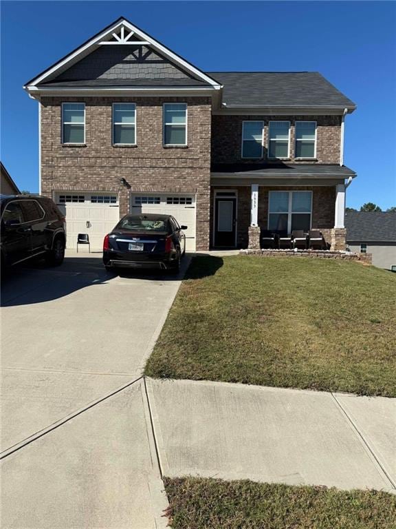 view of front of house featuring a front lawn and a garage