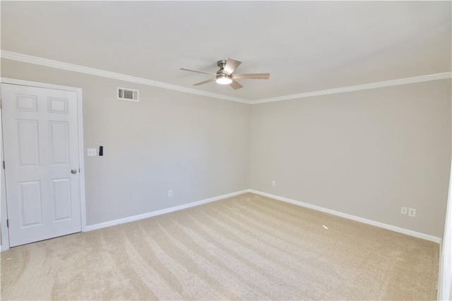 empty room with light carpet, ornamental molding, visible vents, and baseboards