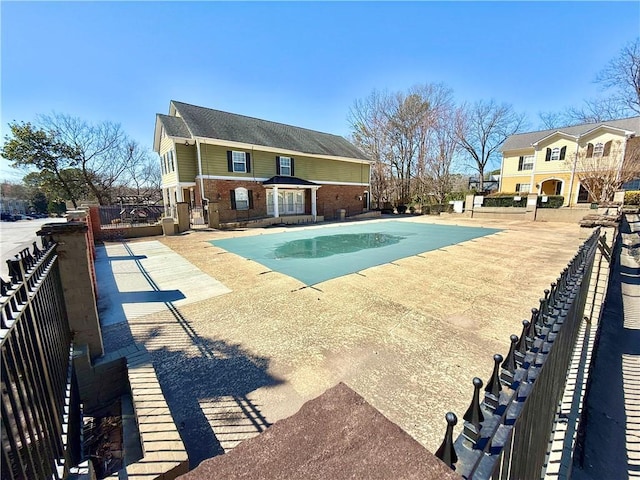 pool featuring a patio area and fence