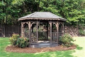 view of home's community featuring a gazebo, a lawn, and fence