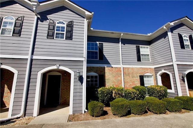 townhome / multi-family property with brick siding